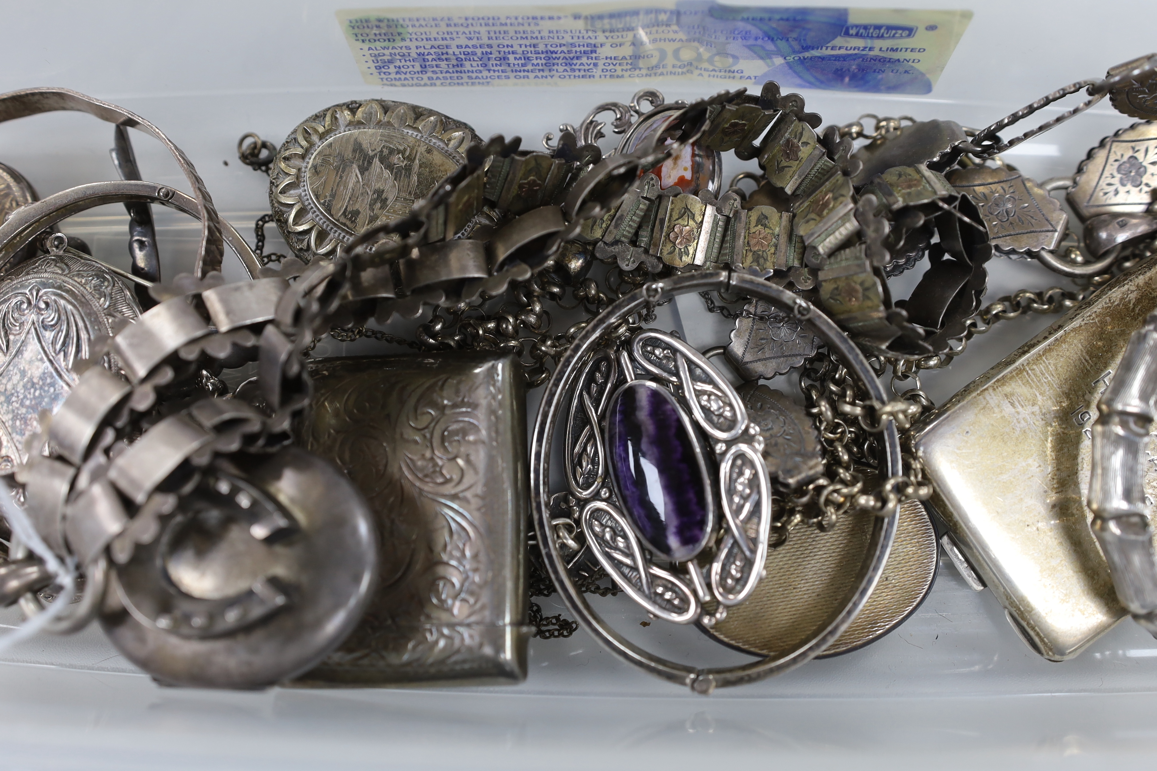 A Victorian silver oval locket, on a white and yellow metal chain, overall 52cm and other jewellery including silver and white metal lockets, vest case etc